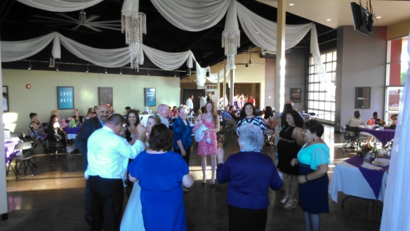 bride and groom with guests dancing during inland empire wedding