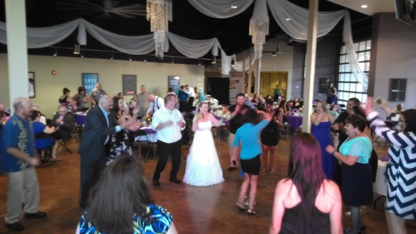 crowd dancing bride and groom in middle